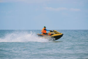 Trainer riding the waves on a jet ski