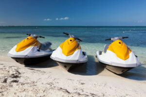 Three rental jet skis on the beach